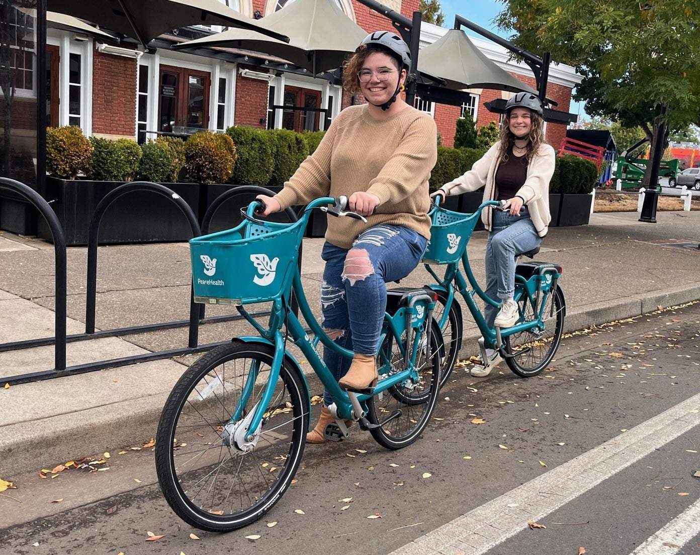 Two students riding PeaceHealth Rides bike share