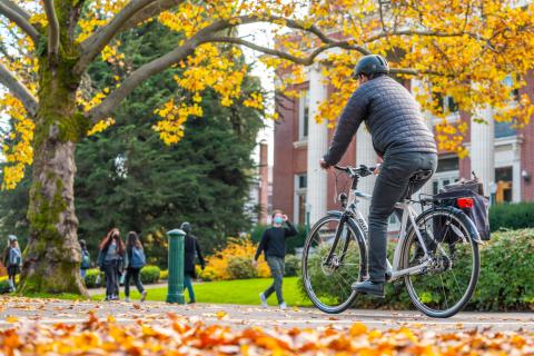 Person riding a bicycle on UO campus