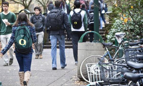 students walking next to parked bikes